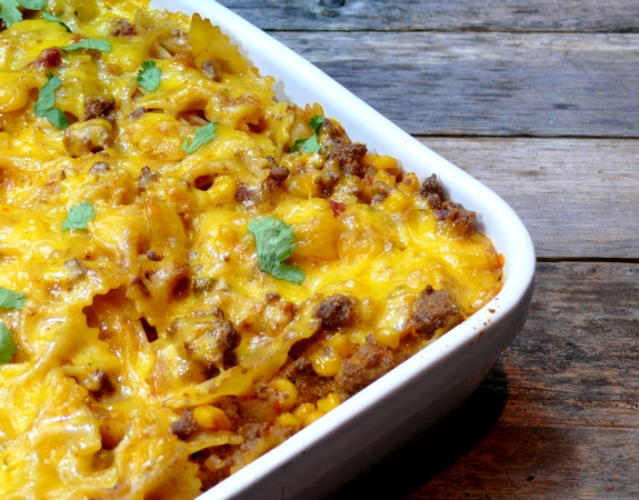 VIDEO + Recipe: Garnish this MEXICAN BOWTIE PASTA BAKE with fresh avocado, sour cream, cilantro and a favorite hot sauce. Makes for great leftovers too from NoblePig.com. #noblepig #cincodemayo #pasta #casserole #mexican