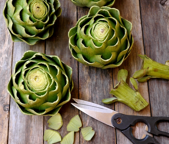 Steamed Artichokes with Garlic Orange Basil Cream Dipping Sauce trimming artichokes