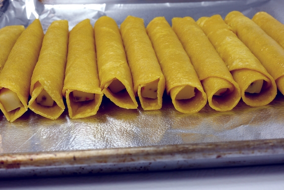 Smokey Soft Taco Roll Ups with Avocado Garlic Dipping Sauce on oven sheet