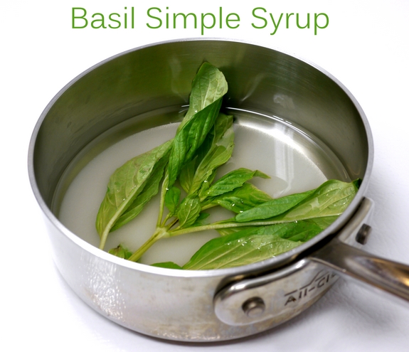 This stone cold, top shelf frozen margarita recipe using frozen nectarines is one for the books. Nectarine-Basil Frozen Margaritas are going to be your new favorite. Basil Simple Syrup in text with basil leaves floating in a pan.