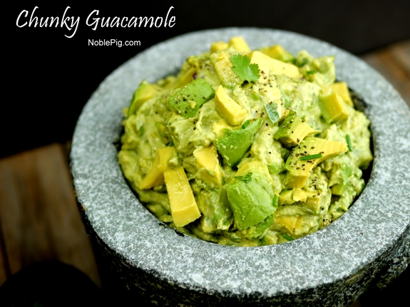 Chunky Guacamole in a bowl with text that reads chunky guacamole.