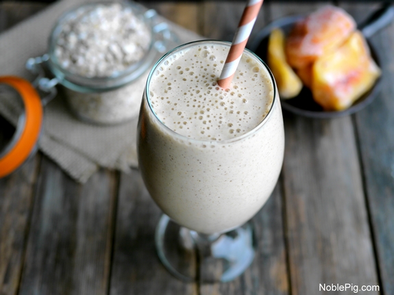 Overhead Peach Cinnamon Oatmeal Smoothie with an orange straw.