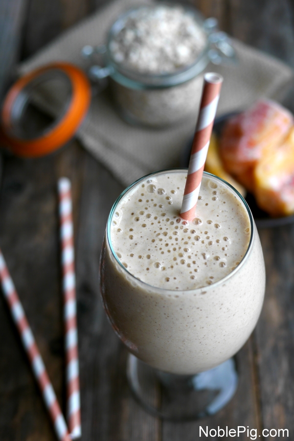 Overhead of Peach Cinnamon Oatmeal Smoothie with an orange straw.