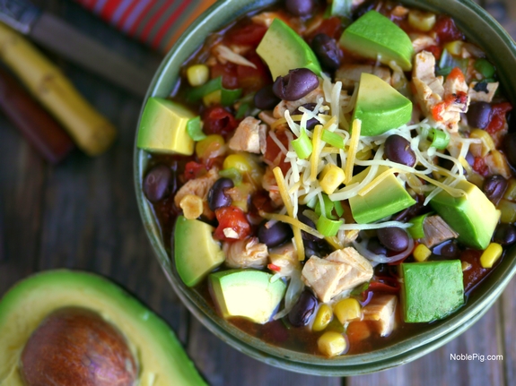 This Mexican Chicken Soup with Avocado will have a delicious and satisfying dinner on the table in 15-minutes. Some nights we need all the help we can get. 15 Minute Mexican Chicken Soup in a bowl.