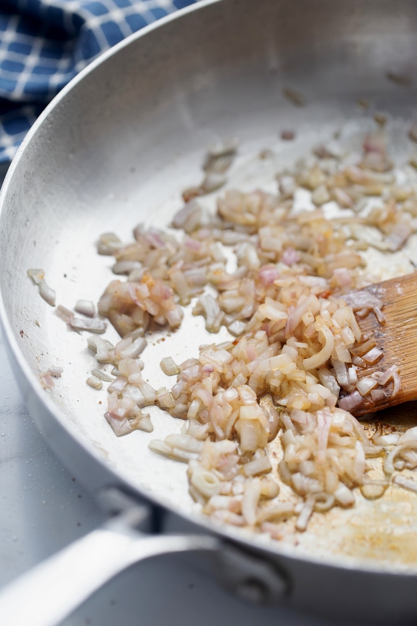 diced shallots in a pan