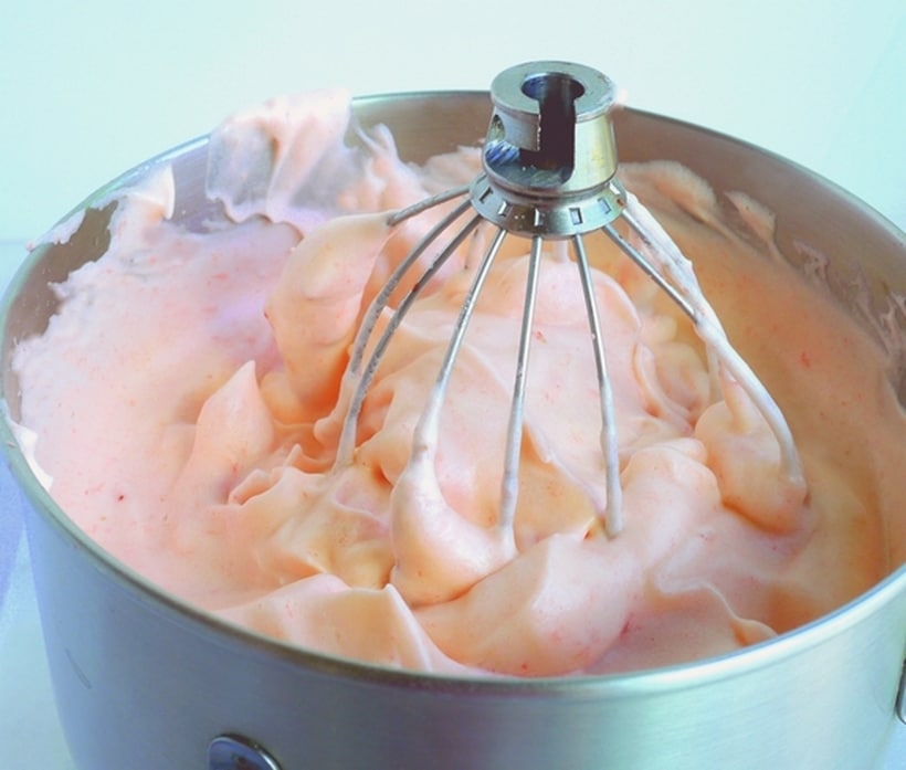 We are all so used to chocolate mousse, it honestly never dawned on me to try a different flavor. And trust me, I do love my chocolate mousse, but sometimes we all love to give something different a try. Whisk attachment in a bowl of strawberry mousse.
