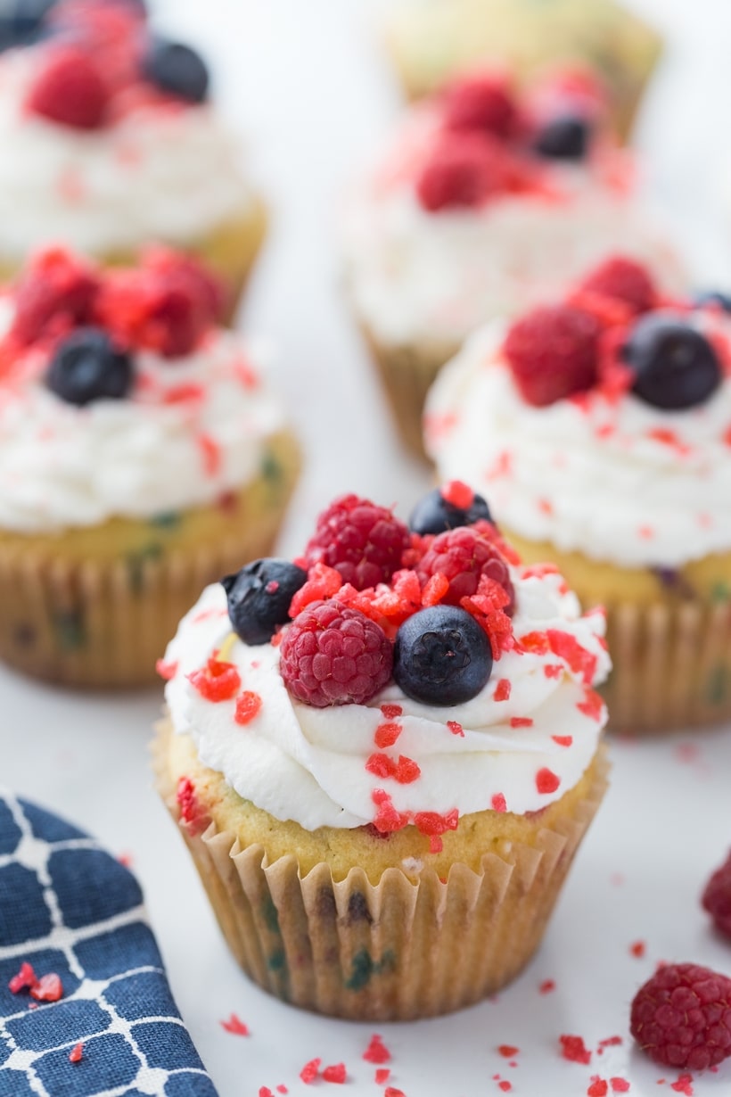 Firecracker cupcakes topped with whipped cream, red and blue berries, and Pop Rocks. 