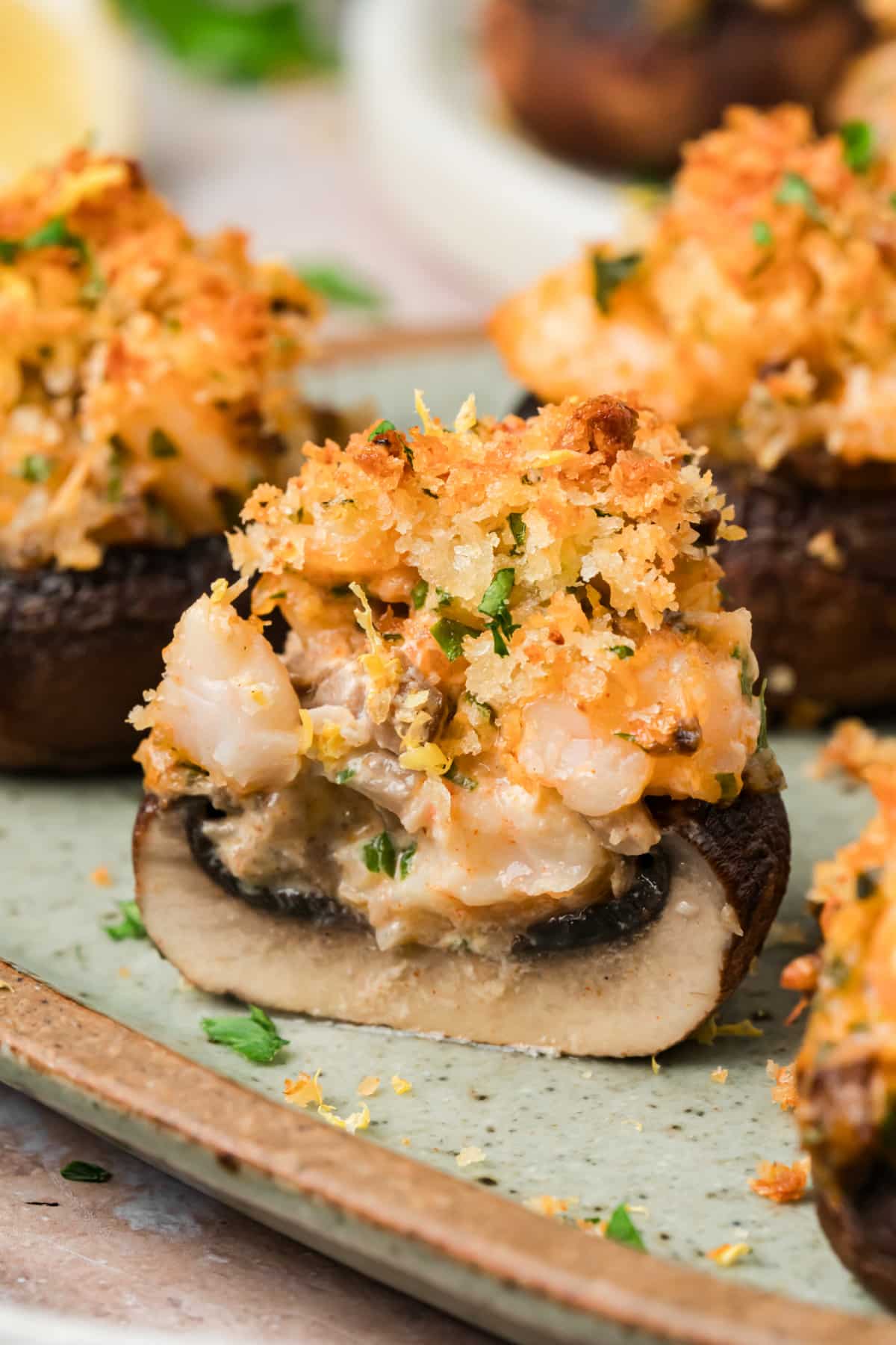 Mushroom stuffed with shrimp and cream cheese showing the chopped shrimp and Parmesan panko topping
