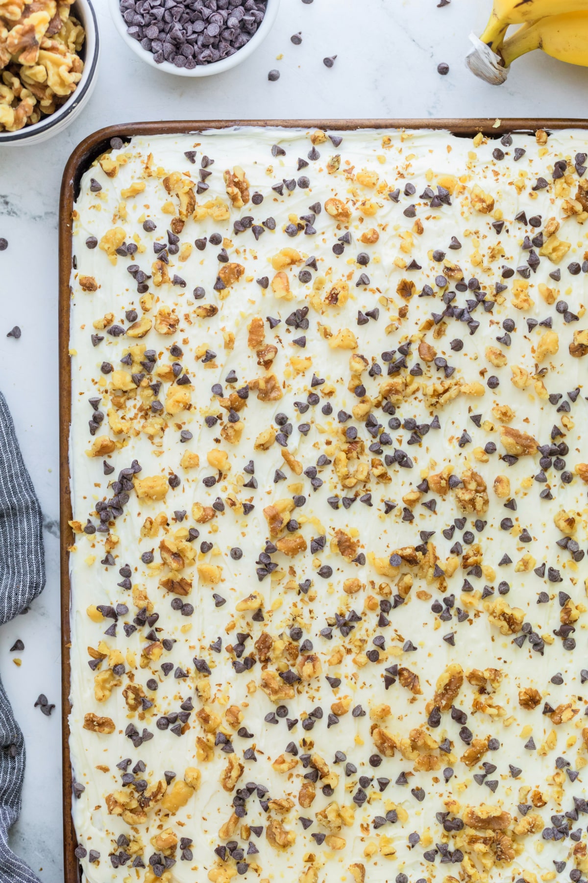 top view of Banana Sheet Cake with Cream Cheese Sour Cream Frosting Overhead view of fully frosted banana sheet cake in a sheet pan.