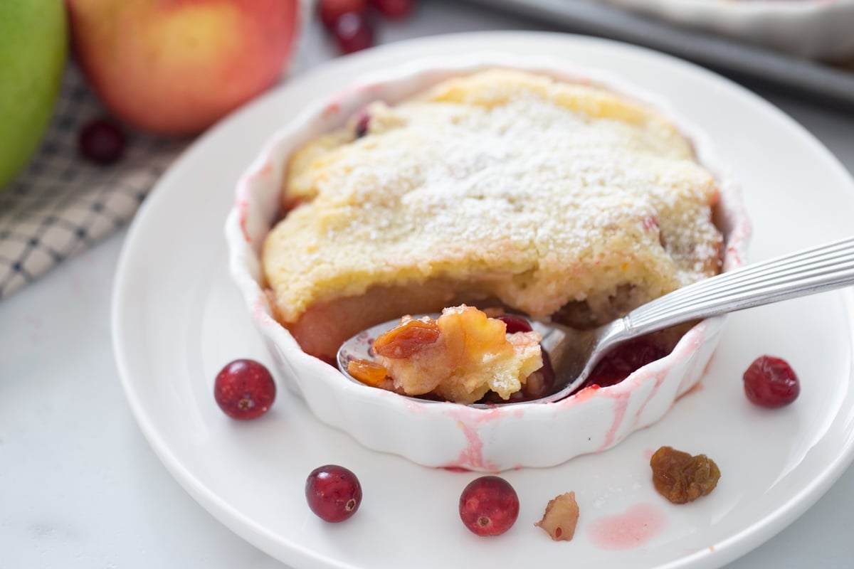 Close-up of baked cranberry apple cobbler showing golden crust.