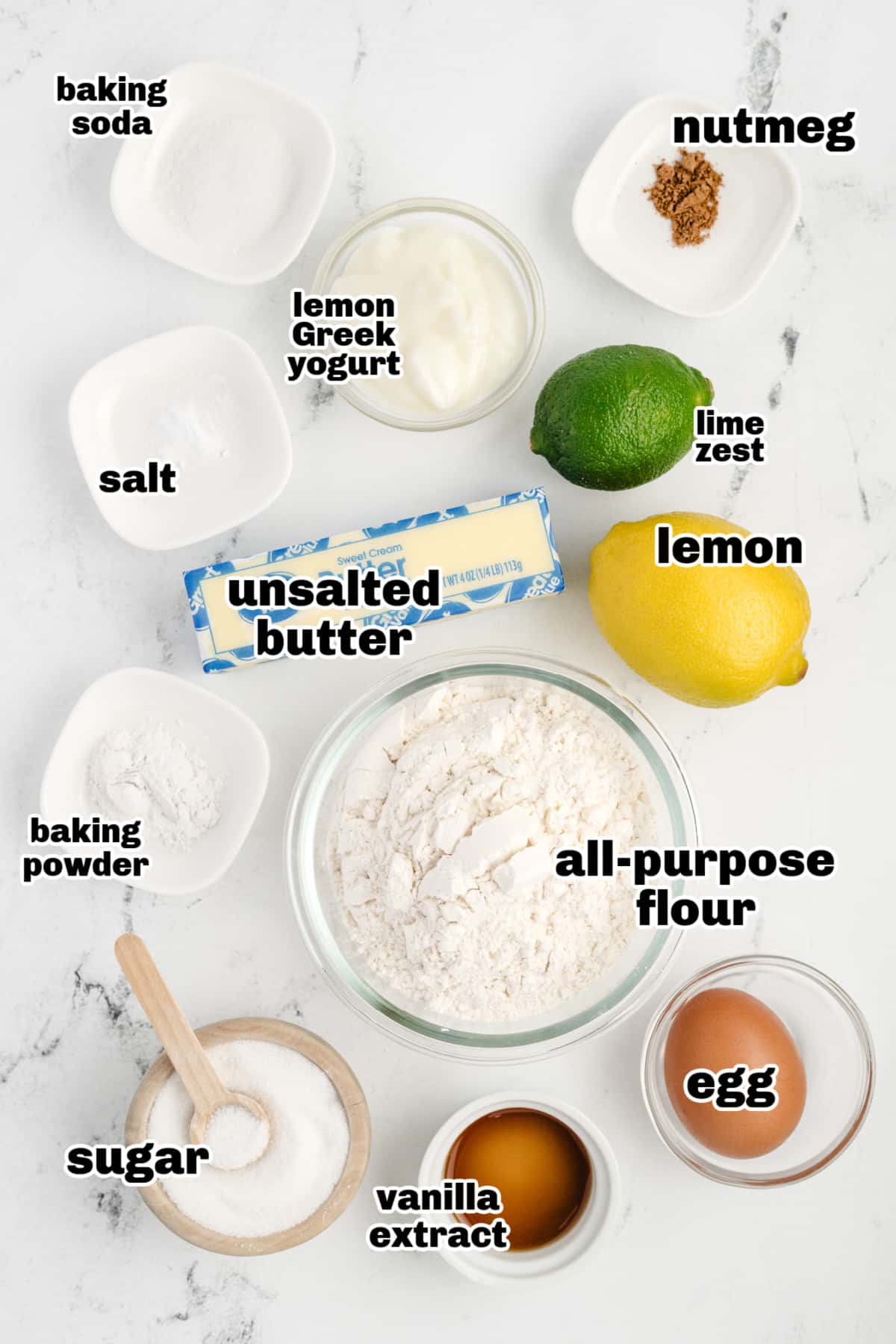 Lemon Muffins with Lime-Scented Sugar ingredients Top-down view of ingredients measured out in small bowls, including yogurt, lemon, and flour