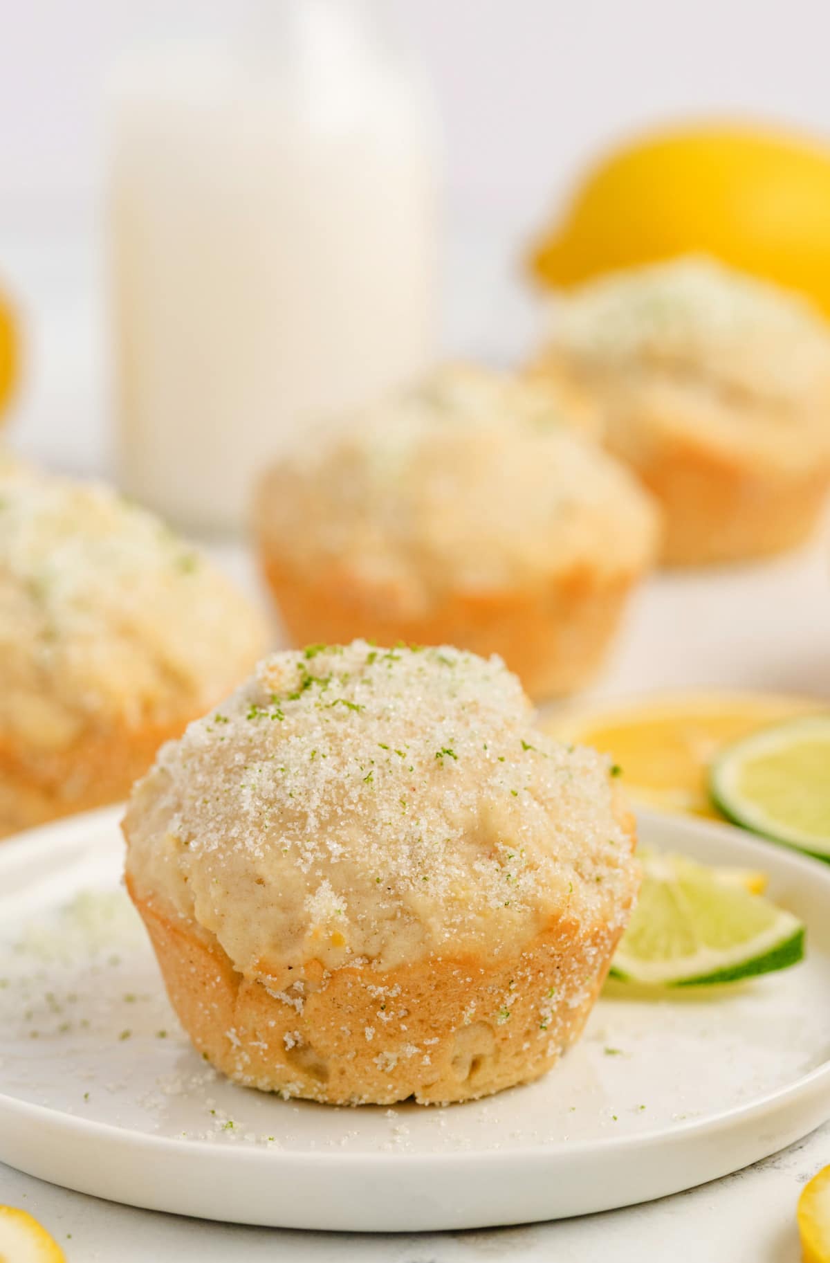Lemon Muffins with Lime-Scented Sugar Close-up of a single lemon muffin with a golden top and sugar-crusted edge