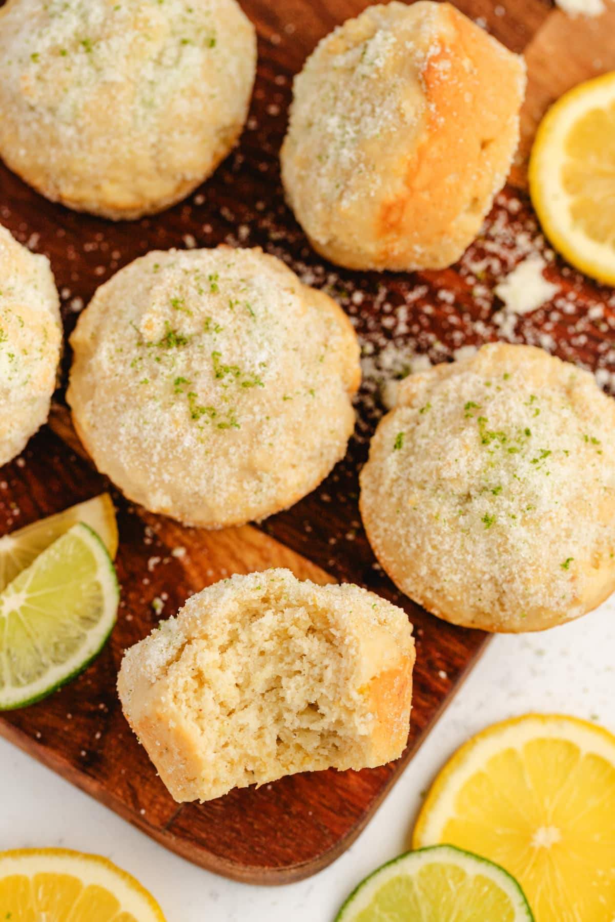 Lemon Muffins with Lime-Scented Sugar on a cutting board Interior shot of a halved muffin showing soft, fluffy texture and lemon flecks