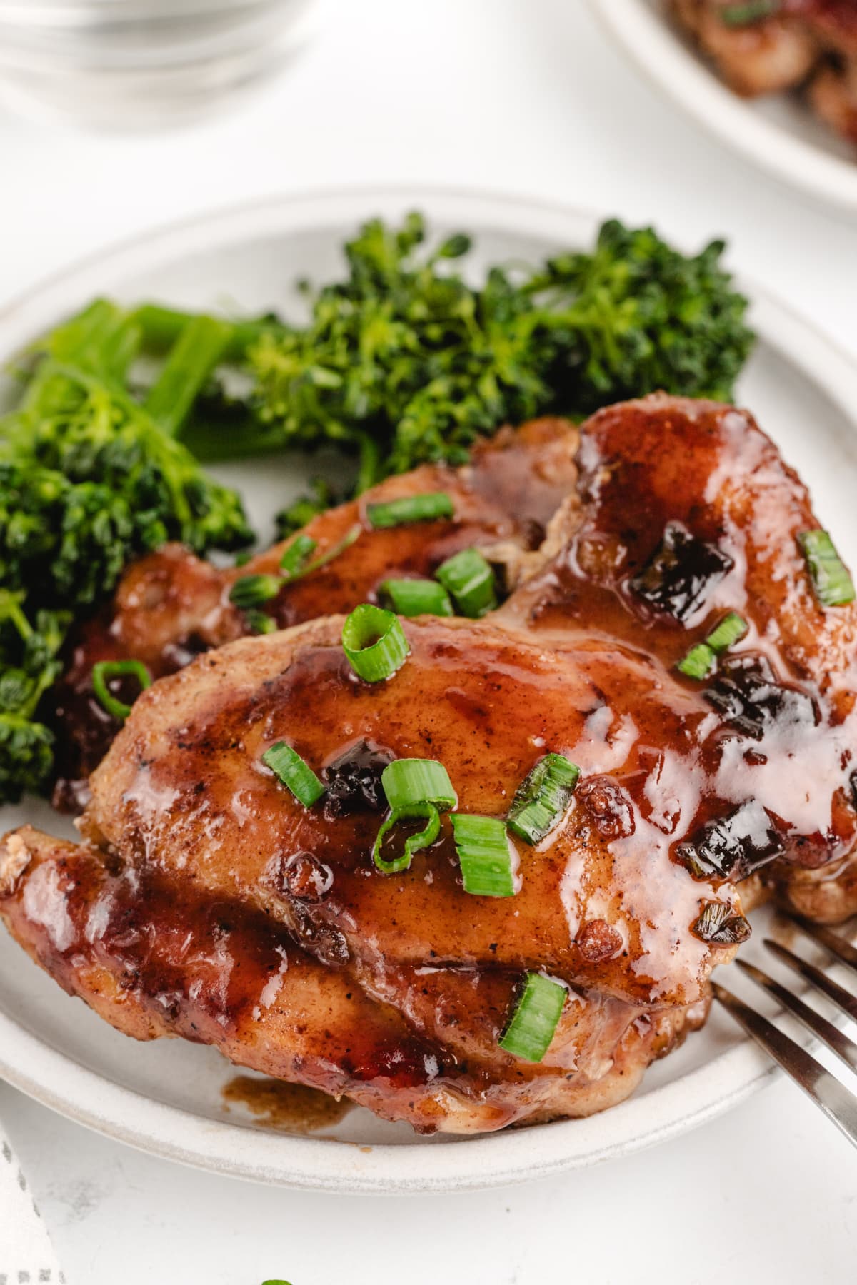 Saucy Plum Chicken ready to eat Close-up shot of sliced saucy plum chicken, showing the tender texture and deep, glossy coating of the plum sauce.