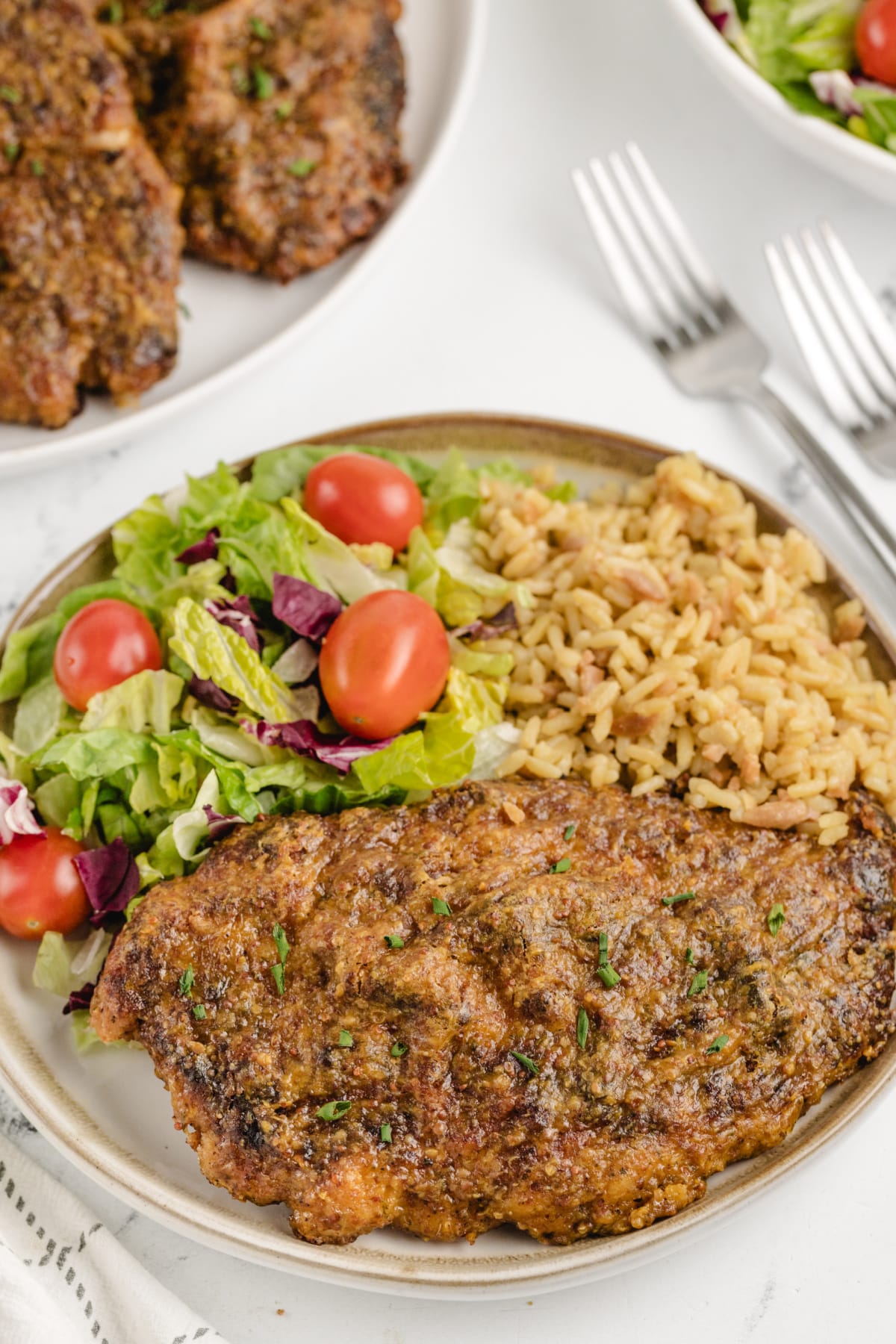 Crispy maple mustard glazed chicken cutlet served with salad and seasoned rice