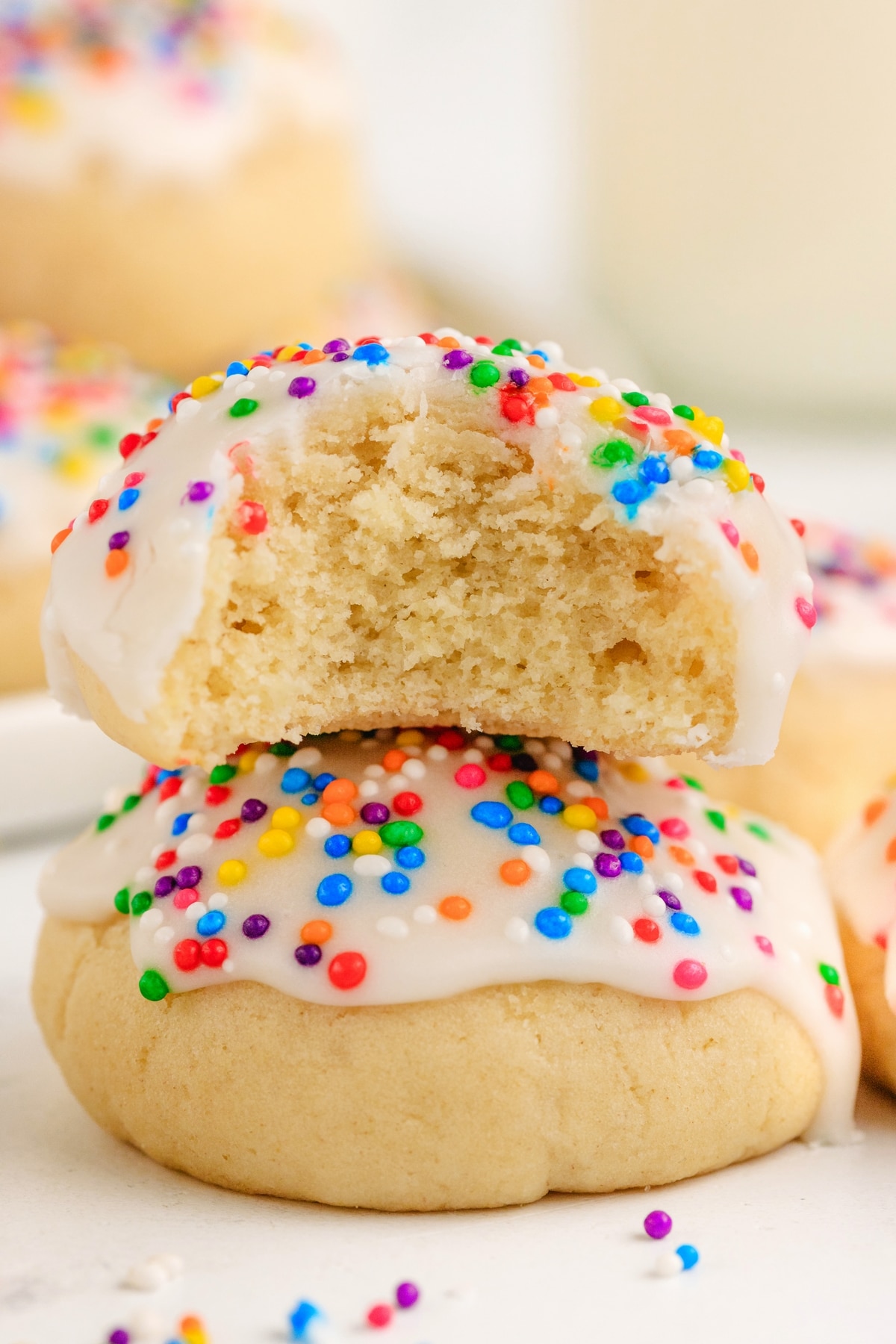 soft Italian cookie broken open showing tender crumb with glaze and sprinkles