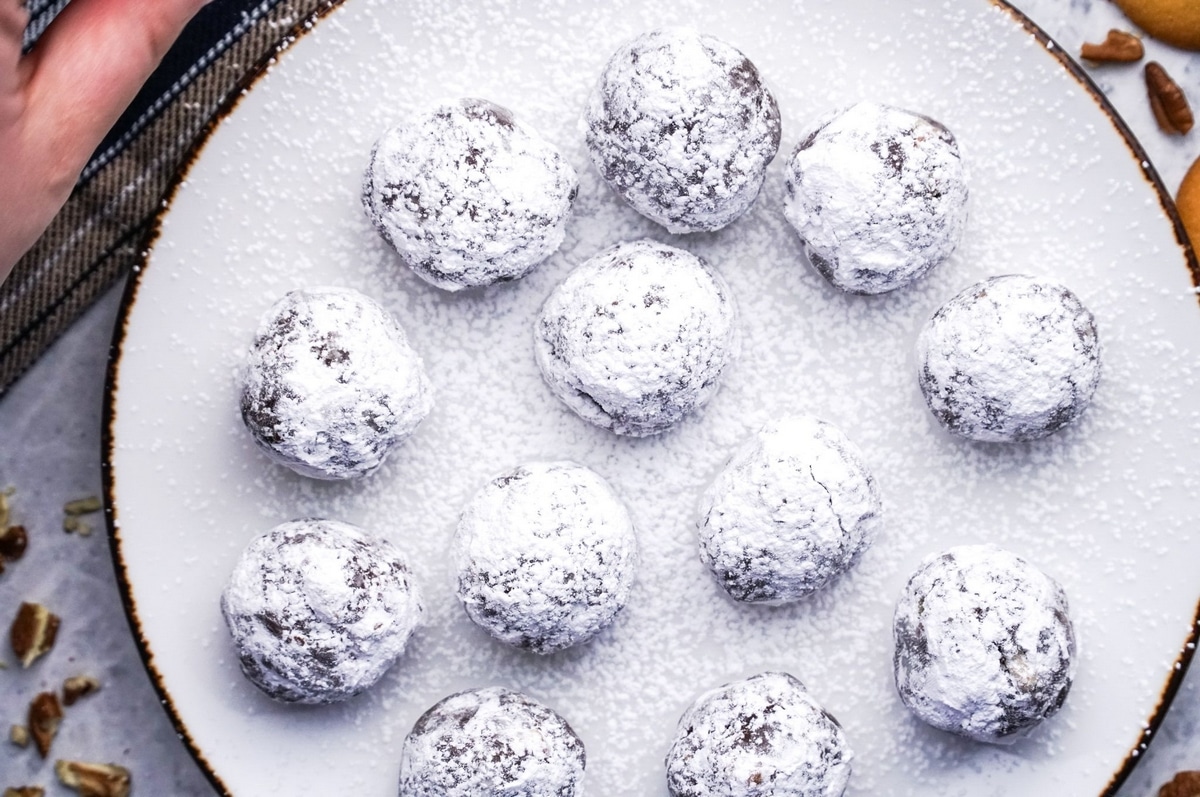 Port Wine Cocoa Bites with powdered sugar on a white plate Port Wine Cocoa Bites dusted with powdered sugar on a white plate.