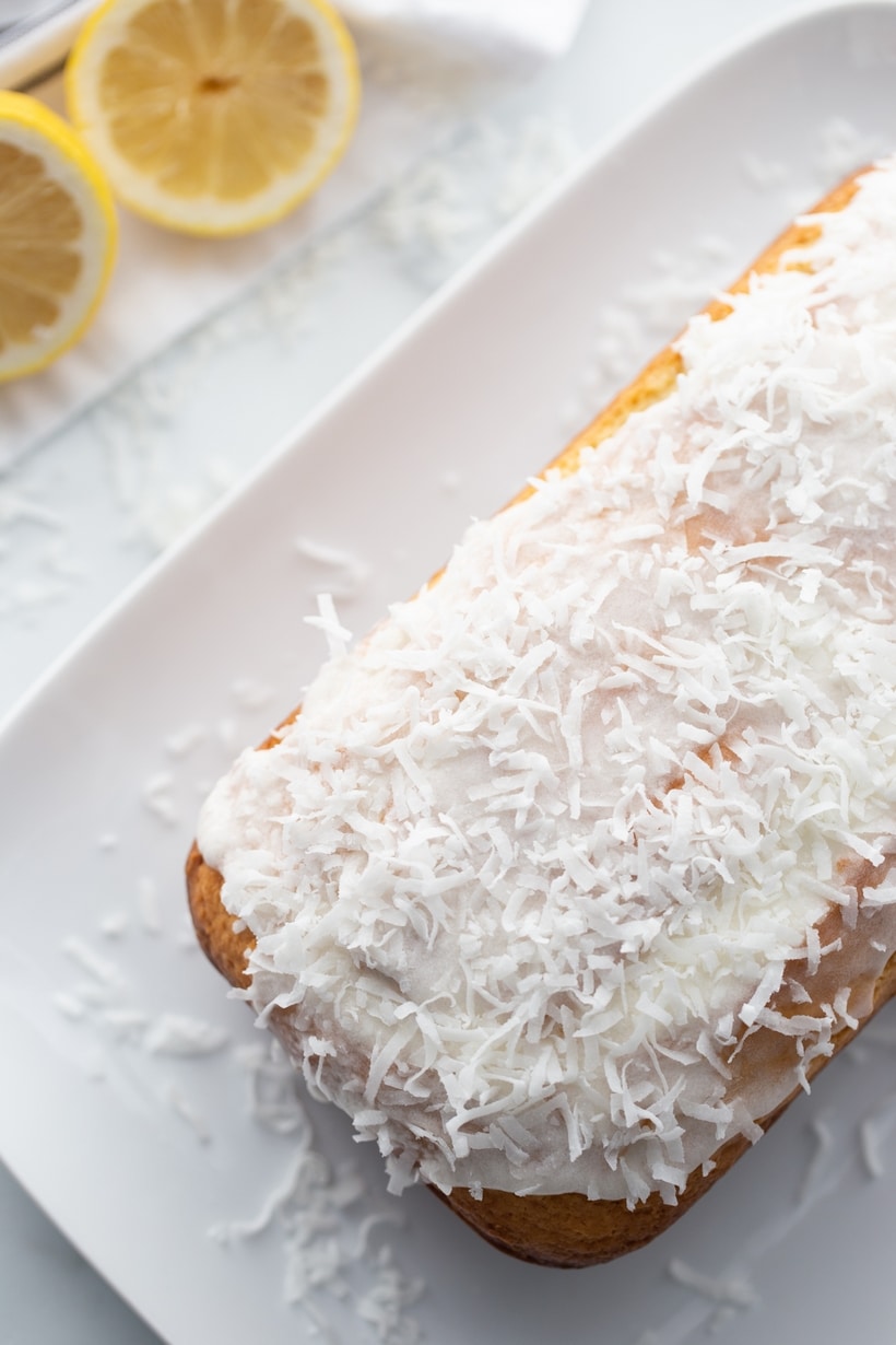 Overhead shot of the full coconut-lemon loaf topped with glaze and coconut.
