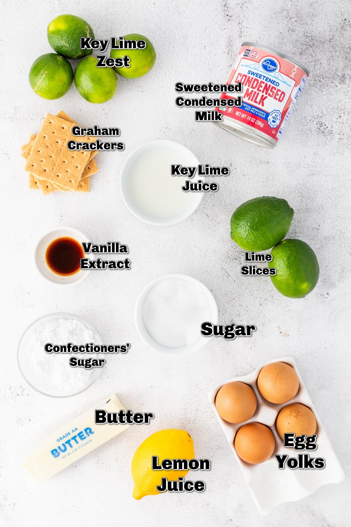 Key lime pie ingredients arranged on counter Ingredients laid out for making key lime pie, including condensed milk, eggs, and graham crackers