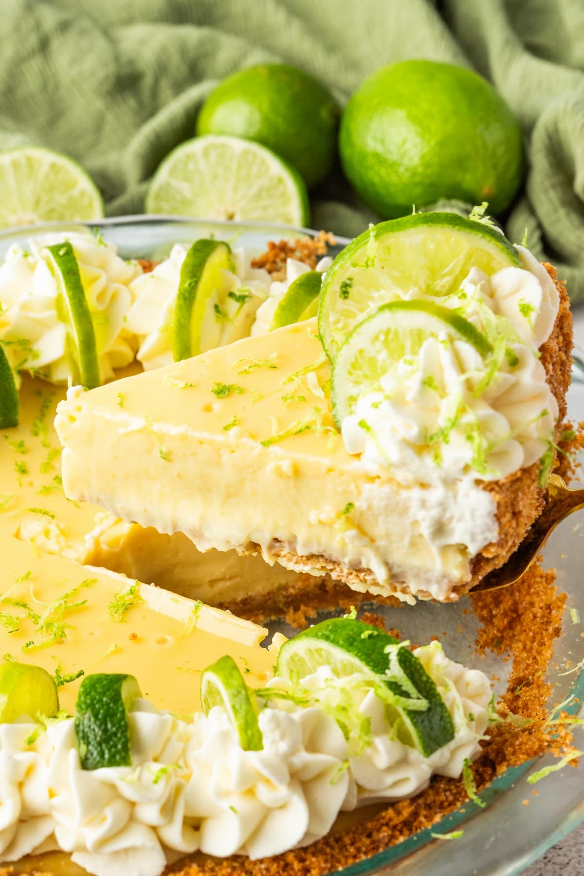Lifting a slice of key lime pie from the pan Slice of key lime pie being lifted out with a spatula