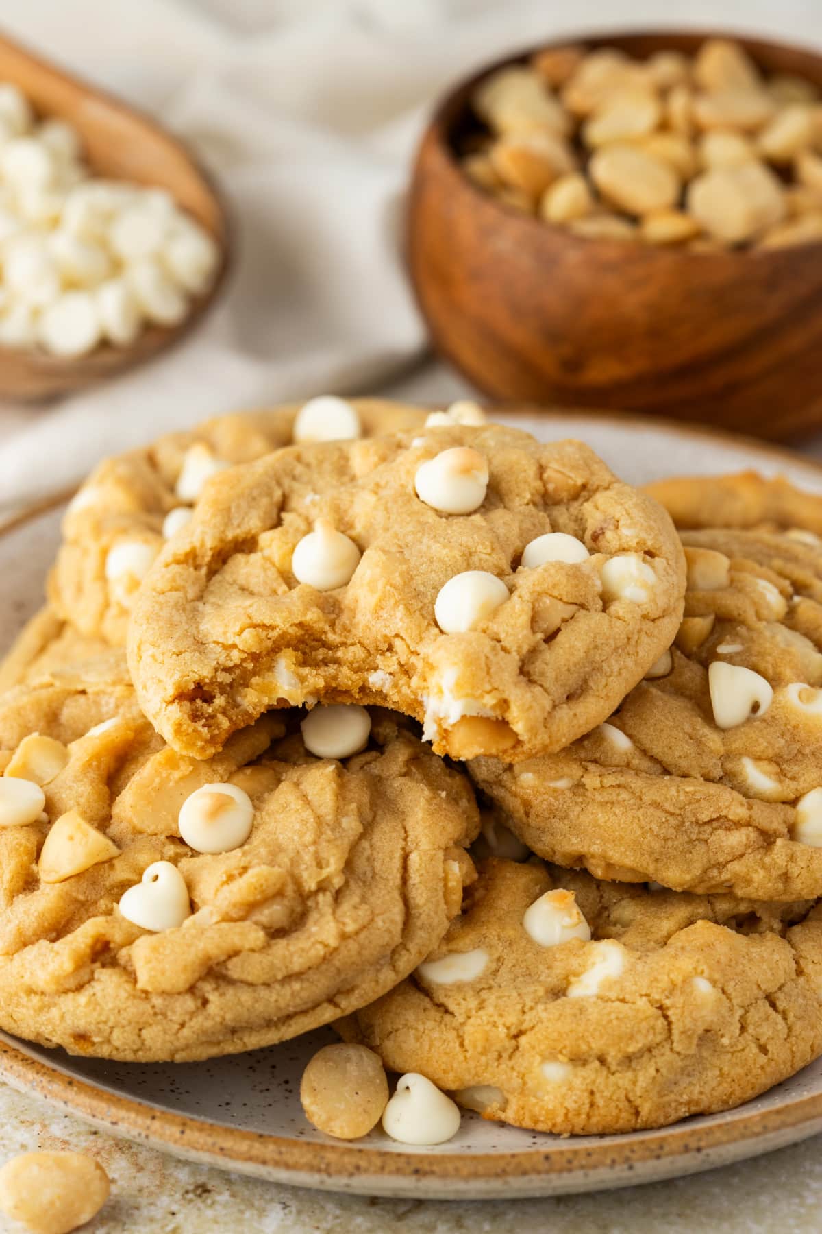 Bakery Style White Chocolate Macadamia Cookies bakery style white chocolate macadamia cookies piled on a plate with soft centers and white chocolate chips