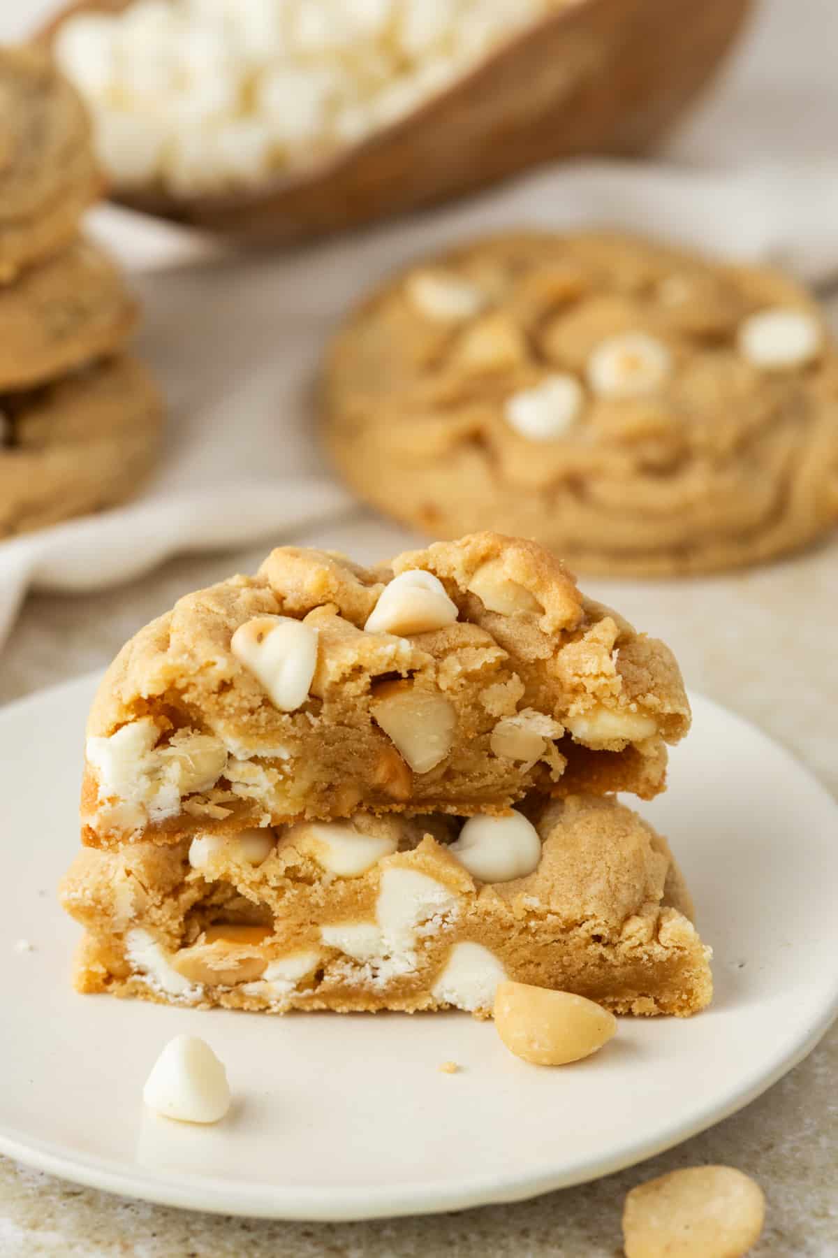 White Chocolate Macadamia Cookie Soft Texture white chocolate macadamia cookie broken open showing soft texture white chocolate chips and macadamia nuts