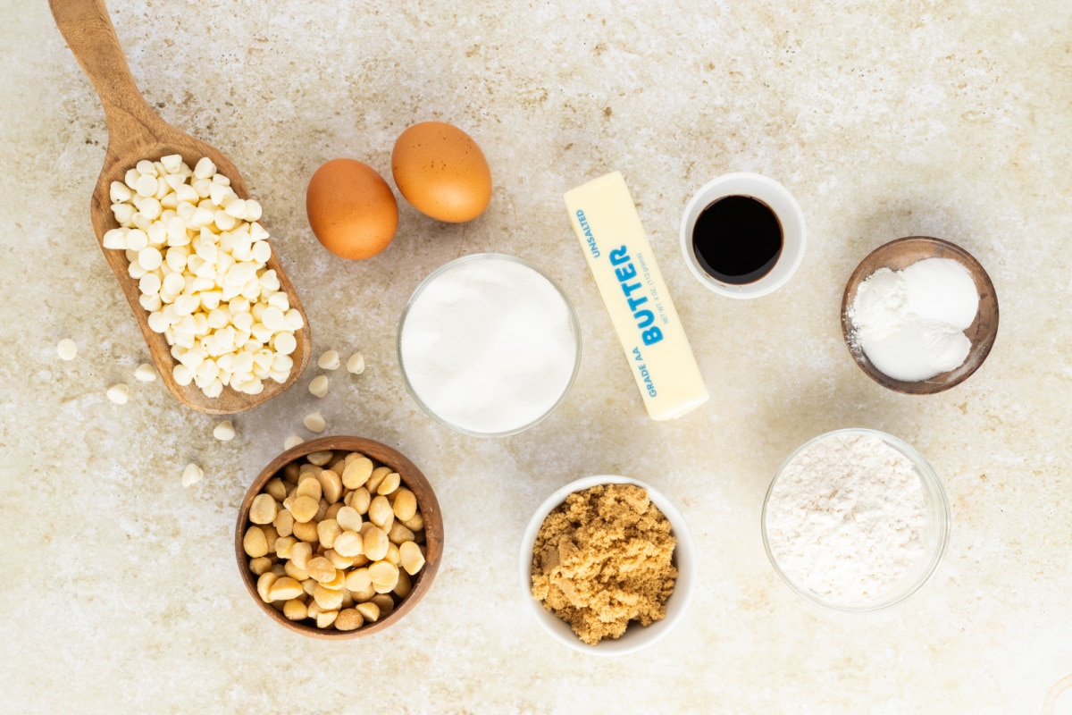 White Chocolate Macadamia Nut Cookie Ingredients ingredients for white chocolate macadamia nut cookies including butter sugar eggs flour white chocolate chips and macadamia nuts
