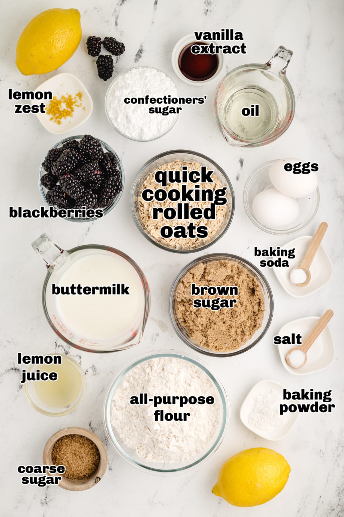  measured ingredients for lemon blackberry oat muffins including buttermilk, flour, and fresh berries