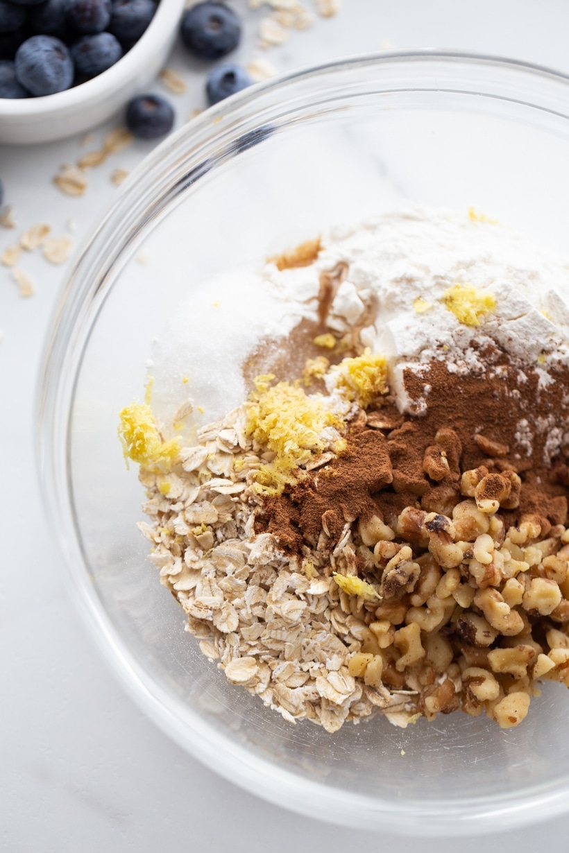 oat topping ingredients in bowl before mixing Clear bowl showing crisp topping ingredients before mixing