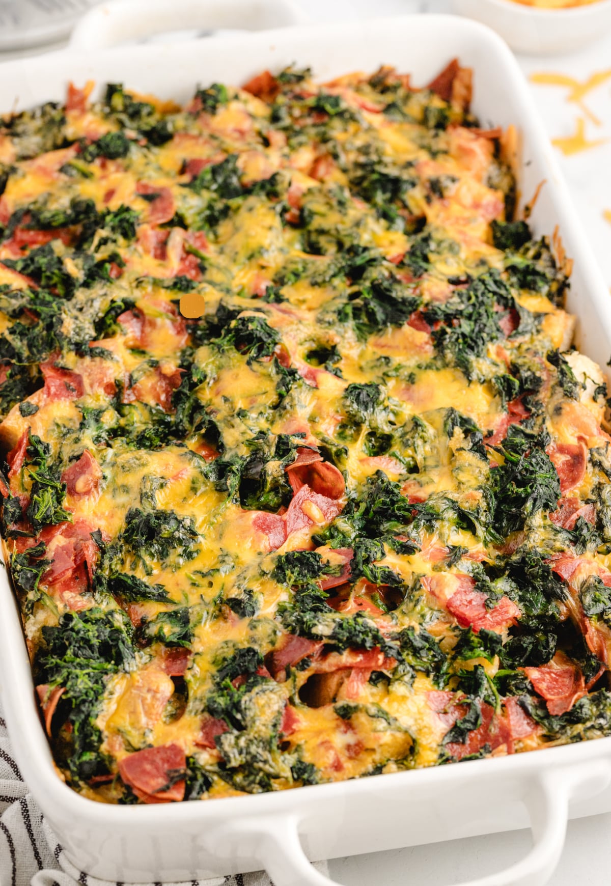Cheesy Pepperoni Strata in a baking dish Baked cheesy pepperoni strata in a 13x9-inch dish with a golden, bubbly top.