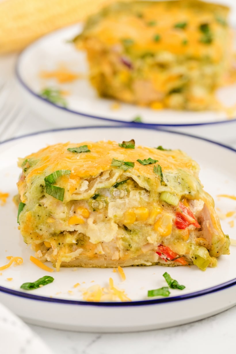 This Chicken Poblano Casserole brings together a creamy, roasted poblano sauce, juicy chicken, gooey cheeses and layers of tortillas that deliver an enchilada-inspired dinner creation you're going to love. This cheesy casserole effortlessly transitions from a comforting weeknight dinner to a show-stopping, flavor-packed dish for festive celebrations. chicken poblano casserole recipe