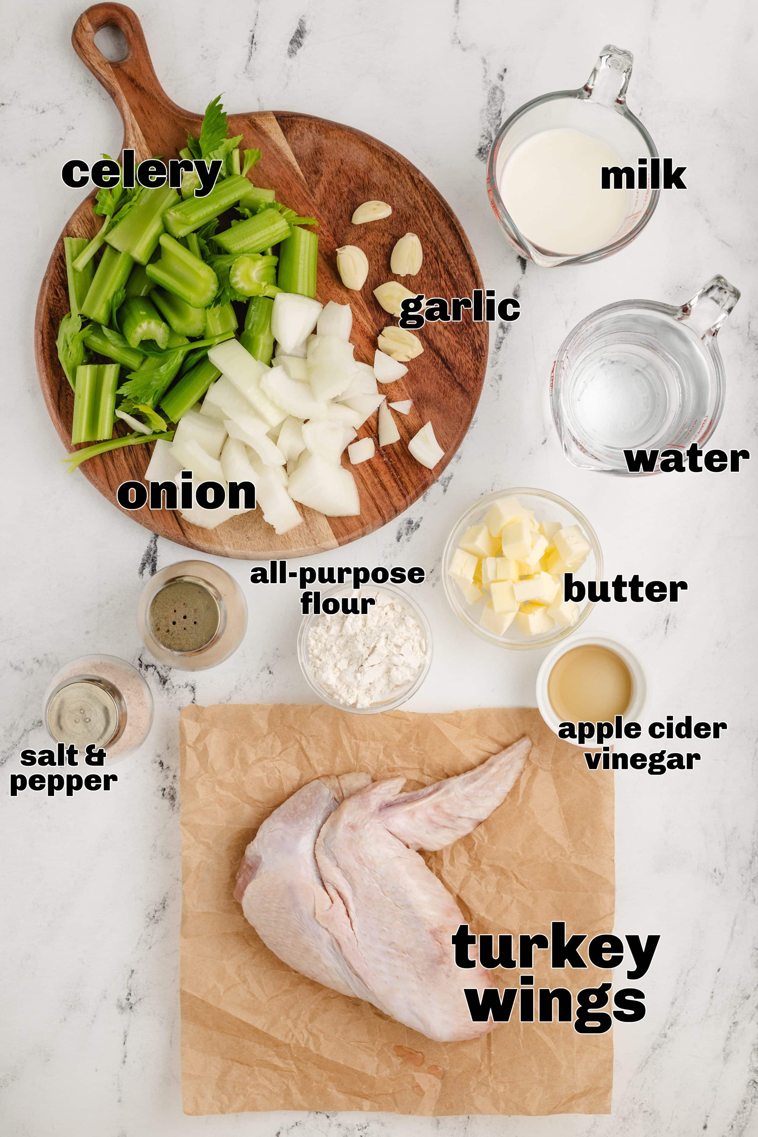 Make holiday prep easier with this Make-Ahead Turkey Gravy – it’s ready a couple of days before, thanks to flavorful turkey wings. Labeled ingredients for make ahead turkey gravy including turkey wings, celery, onion, garlic, butter, flour, milk, apple cider vinegar, salt, and pepper.