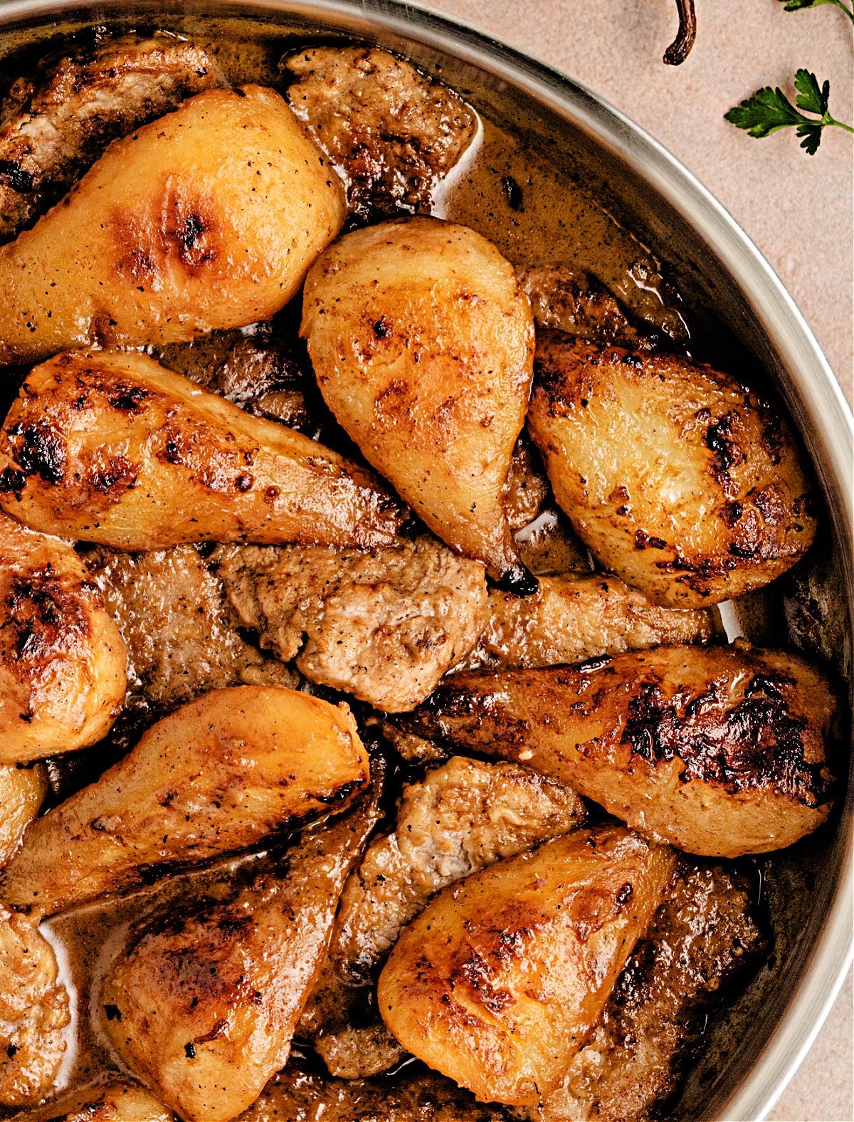 Overhead shot of vanilla cider pork tenderloin with caramelized pears in a buttery cider-vanilla sauce, by Noble Pig.