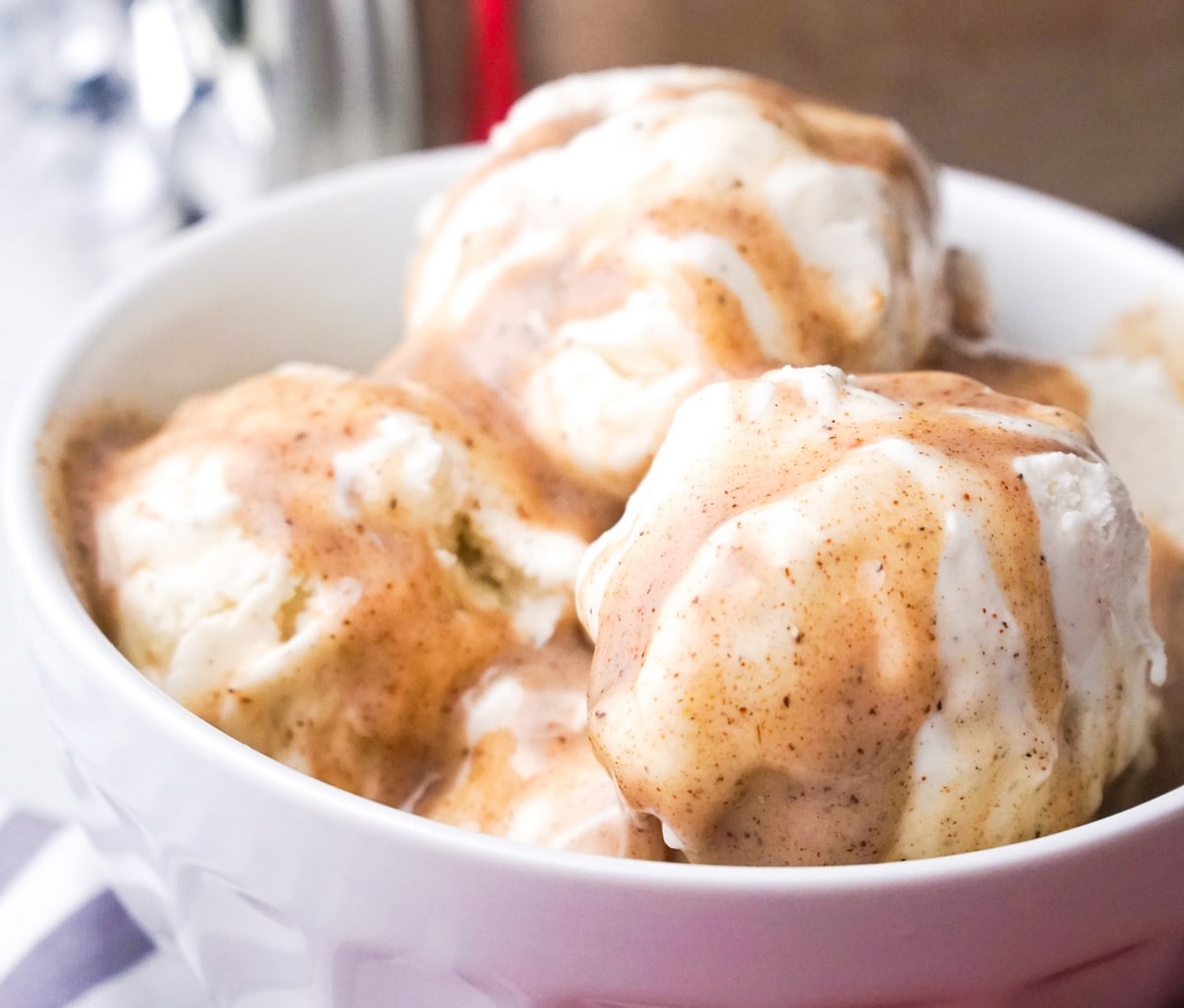 Close-up of vanilla ice cream with chai syrup topping