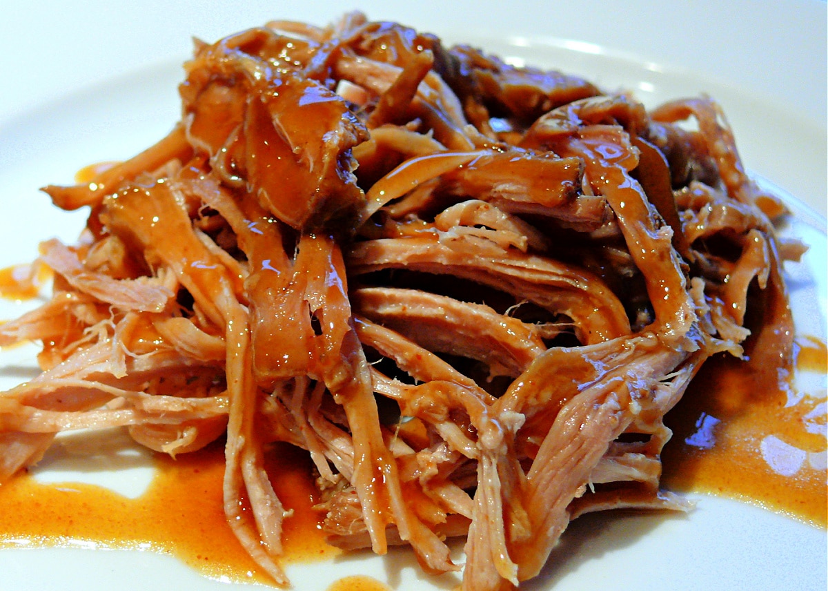 Pulled pork topped with Carolina-style brown sugar vinegar BBQ sauce, tangy vinegar-based sauce with molasses, butter, and brown sugar.