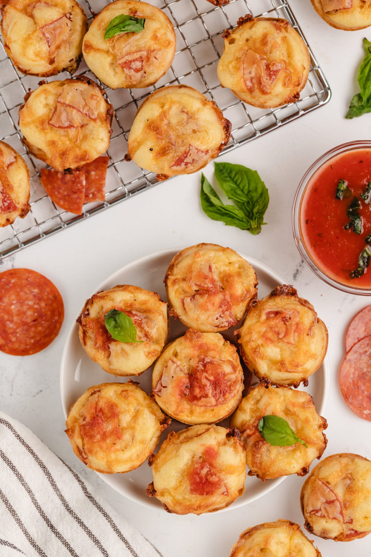 A plate filled with golden brown pepperoni pizza puffs, showing pepperoni peeking out the top.