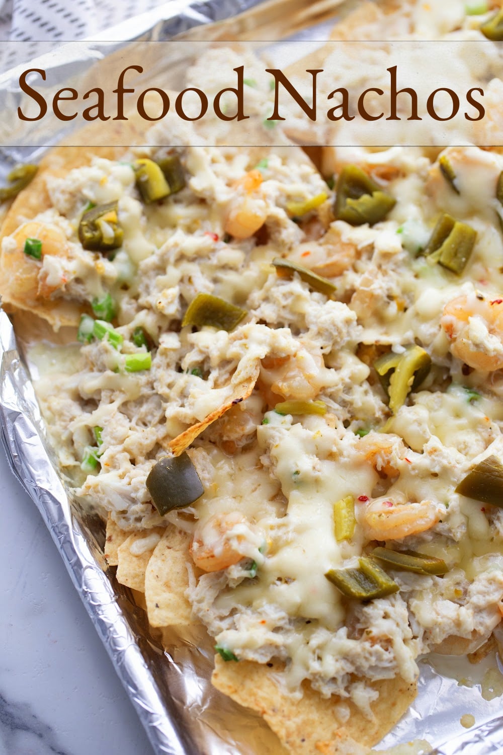 Enhancing the traditional combo of tortilla chips, melted cheese, and pickled jalapenos with shrimp and crab gives these Seafood Nachos a unique flair. They're not just a great pre-dinner but; they can also hold their own as a substantial meal if needed. This loaded seafood nachos recipe is easy to make and makes great party food. via @cmpollak1