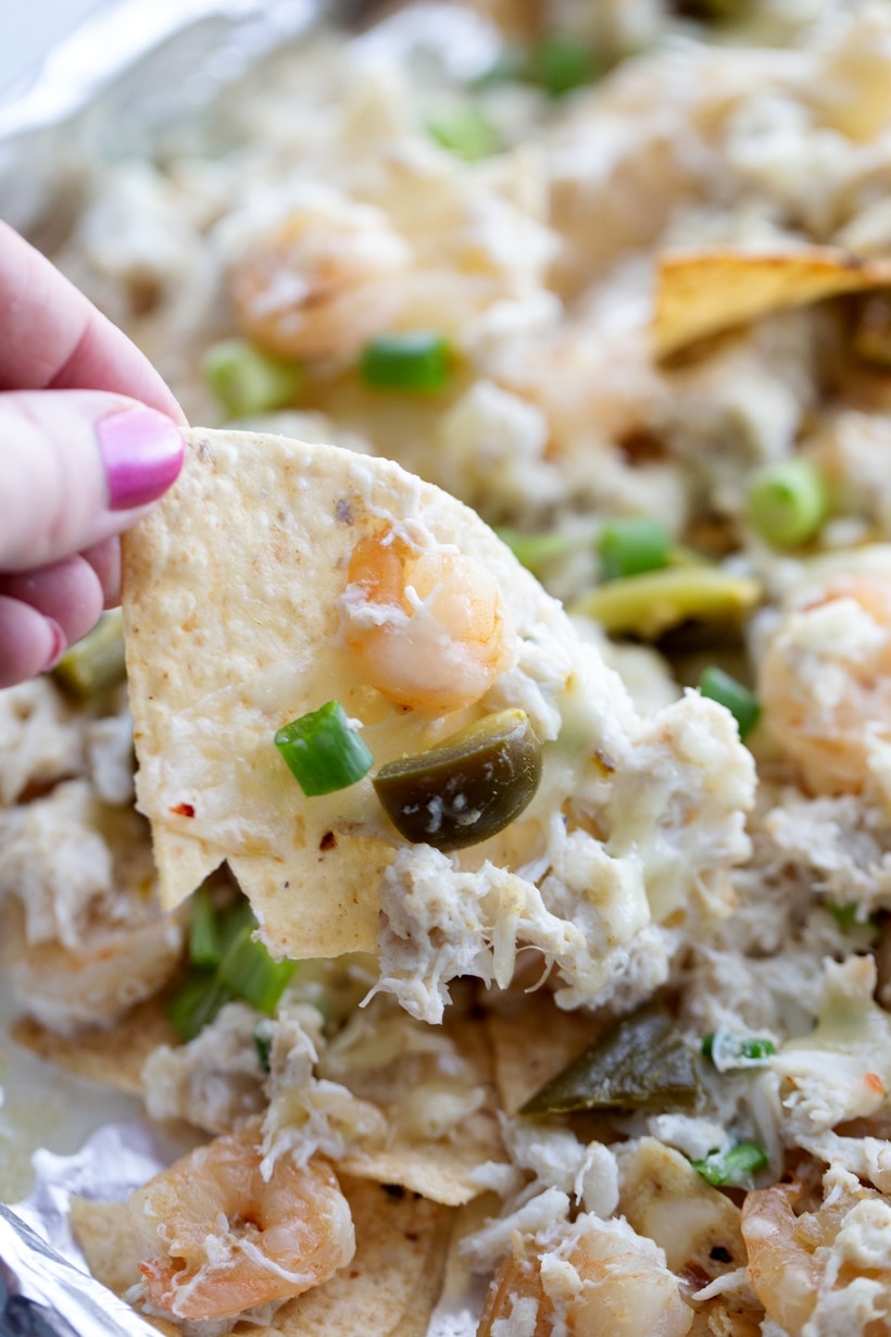 Enhancing the traditional combo of tortilla chips, melted cheese, and pickled jalapenos with shrimp and crab gives these Seafood Nachos a unique flair. They're not just a great pre-dinner but; they can also hold their own as a substantial meal if needed. This loaded seafood nachos recipe is easy to make and makes great party food. nacho shrimp recipe