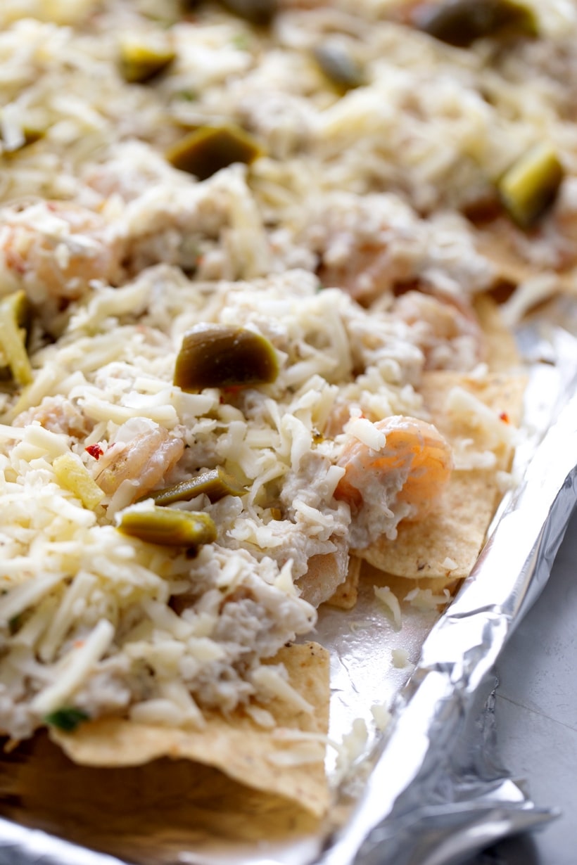 Enhancing the traditional combo of tortilla chips, melted cheese, and pickled jalapenos with shrimp and crab gives these Seafood Nachos a unique flair. They're not just a great pre-dinner but; they can also hold their own as a substantial meal if needed. This loaded seafood nachos recipe is easy to make and makes great party food. crab meat nachos