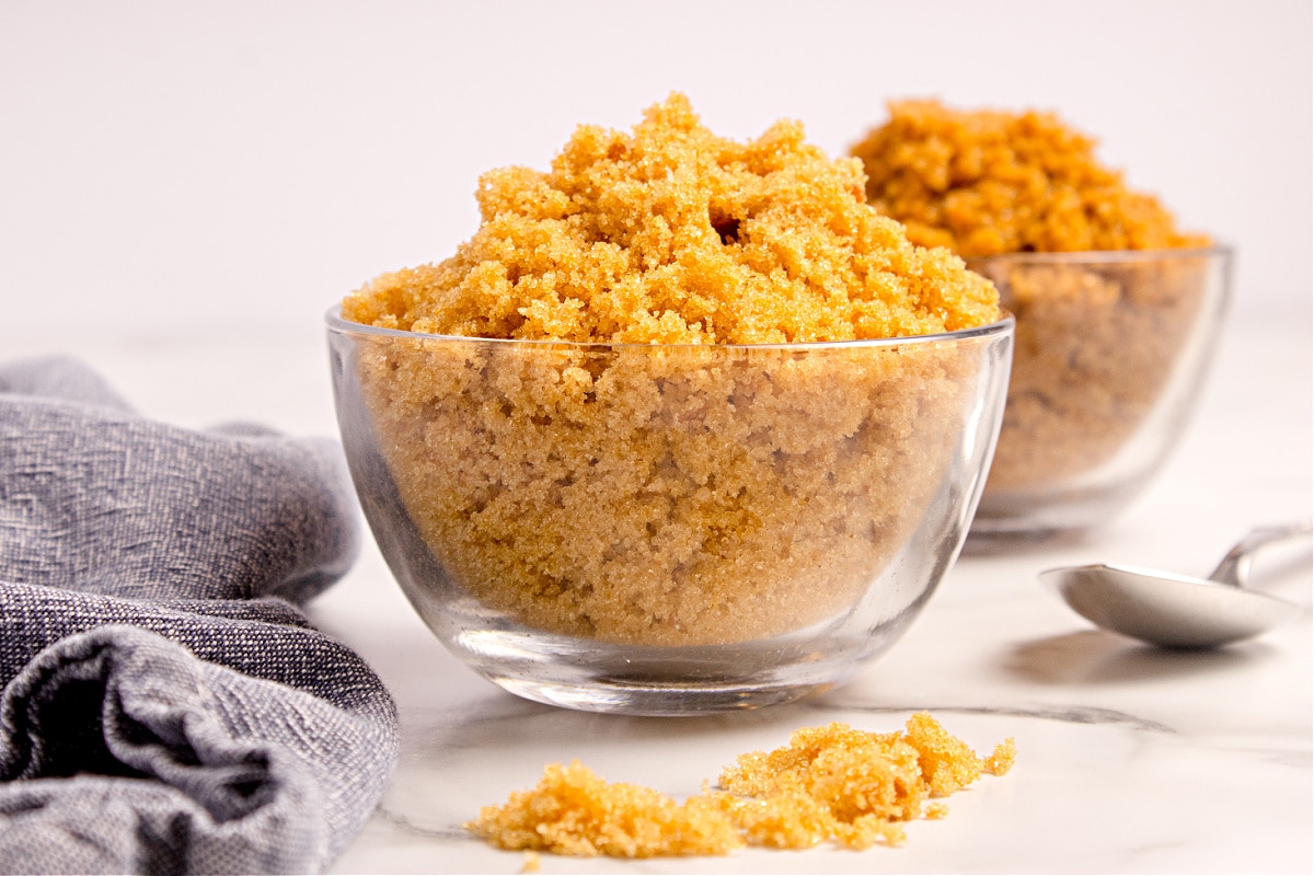 Homemade light brown sugar mixed to a soft, even texture. Homemade light brown sugar in a clear glass bowl with soft, evenly blended sugar and molasses, showing the crumbly texture and rich caramel color.