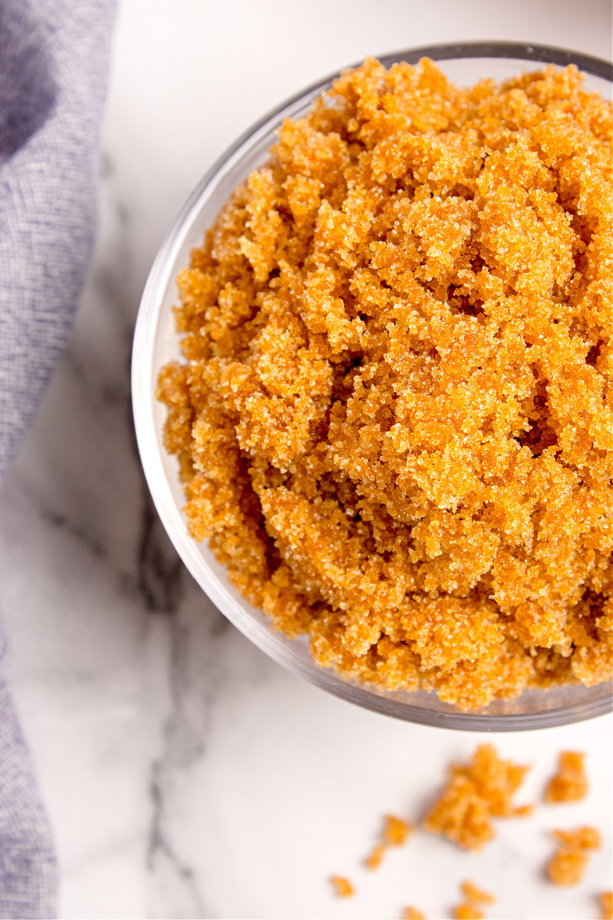 Homemade light brown sugar mixed to a soft, even texture. A close-up shot of homemade brown sugar in a glass bowl, showing the soft, sandy texture and rich caramel color.