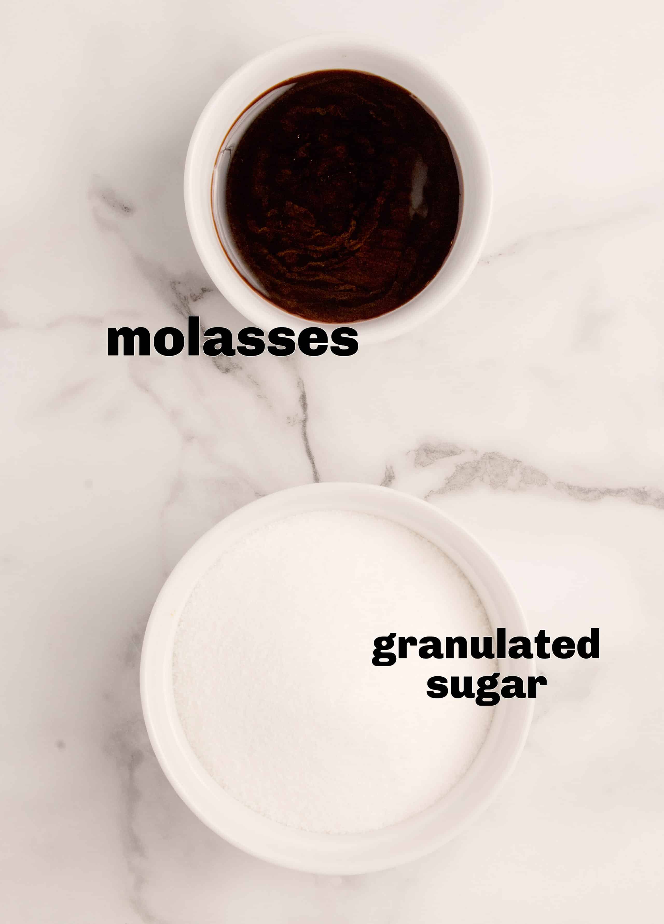 Freshly made brown sugar in two glass bowls. Two glass bowls filled with freshly mixed light and dark brown sugar, showing the soft, crumbly texture and rich molasses color on a marble surface.