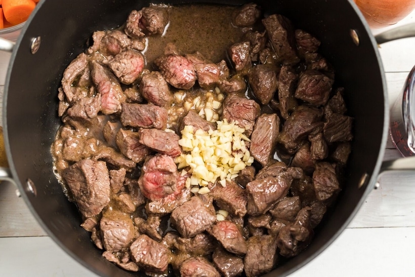 making Beef Irish Stew Close-up of beef cubes browning in a large pot, with a rich sear developing on the surface.