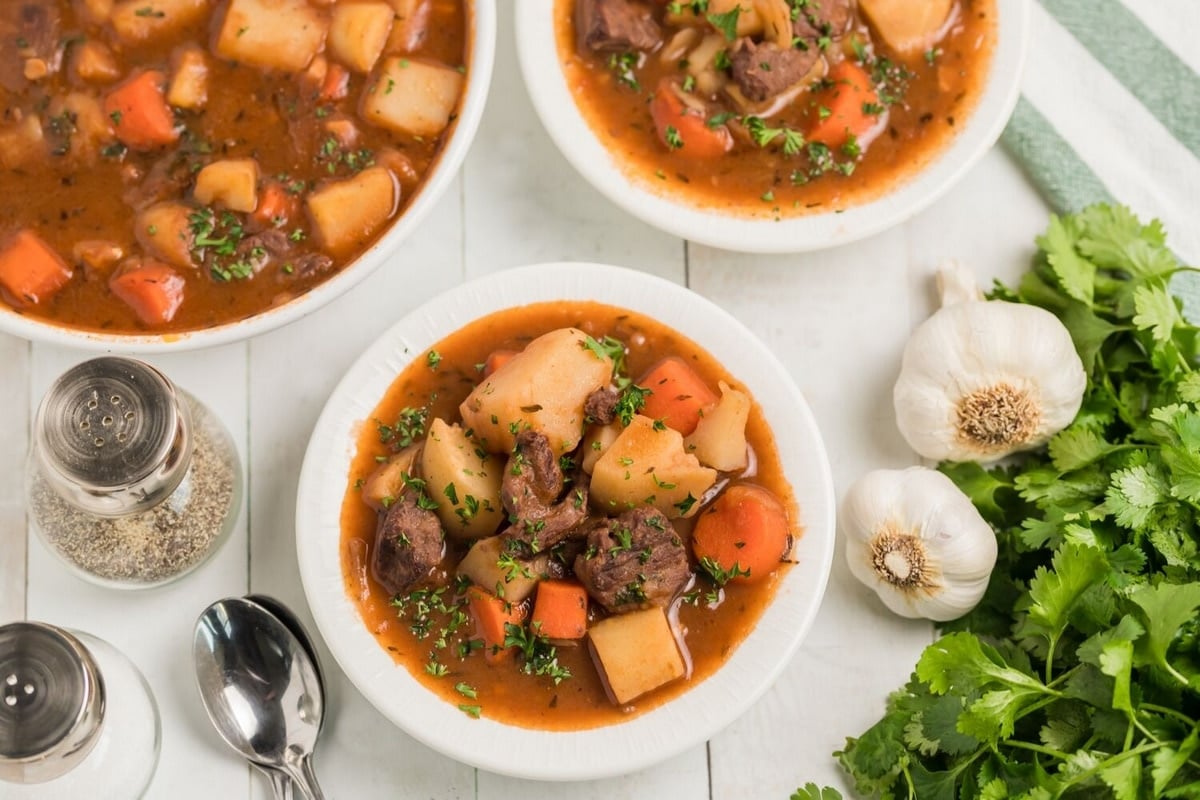 Beef Irish Stew in bowls A side angle of a bowl of Beef Irish Stew, showing the deep color of the broth and hearty ingredients.