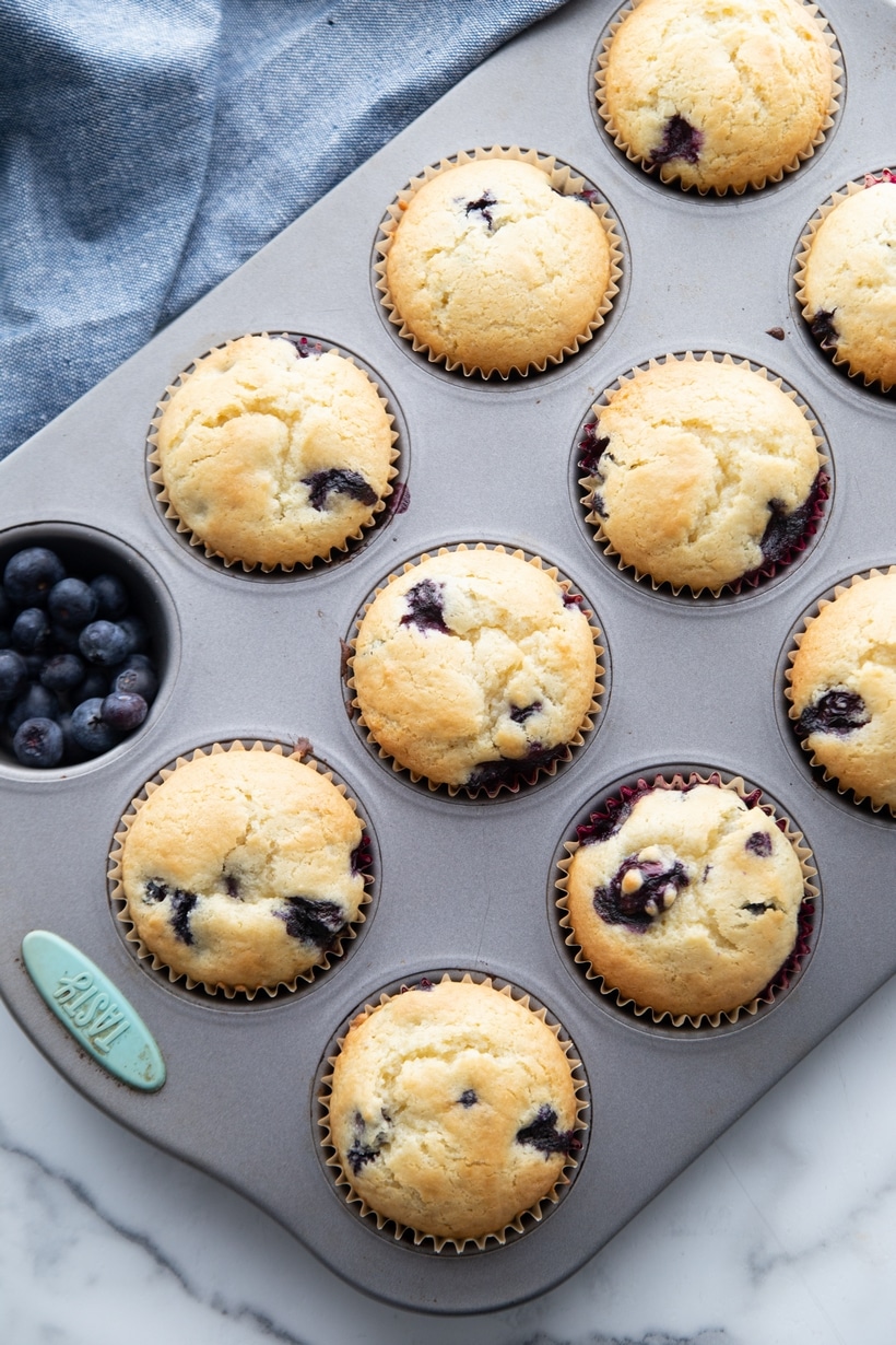 sour cream blueberry muffins baked in a muffin tin