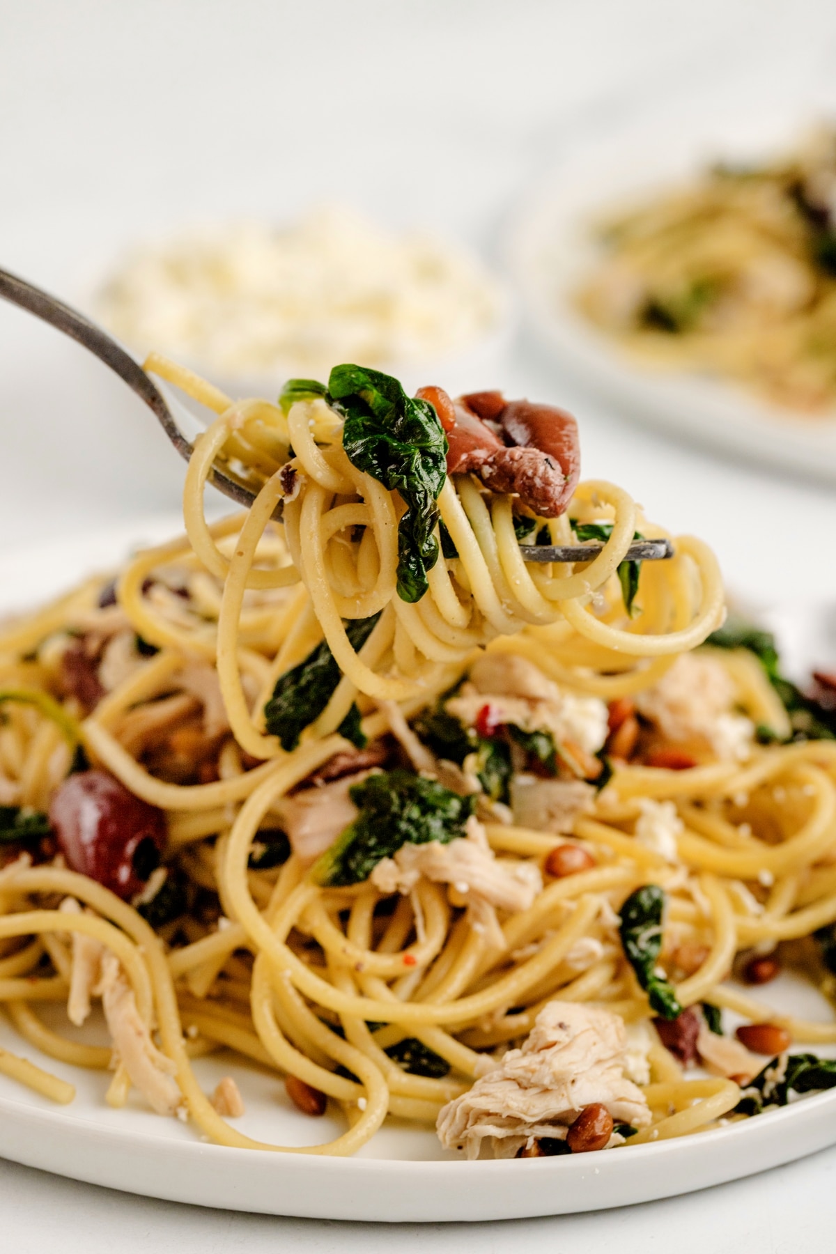 Greek chicken pasta for dinner. a forkful of Greek chicken pasta