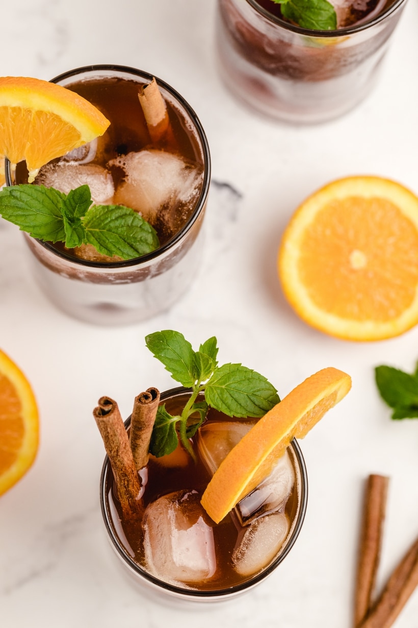 Cinnamon Orange Sweet Tea is not your typical backyard barbecue iced tea, it's so much better! This next level sweet tea uses cinnamon and ginger to highlight the sweetness of the added sugar and bring the citrus undertones to life! full glass of flavored sweet tea