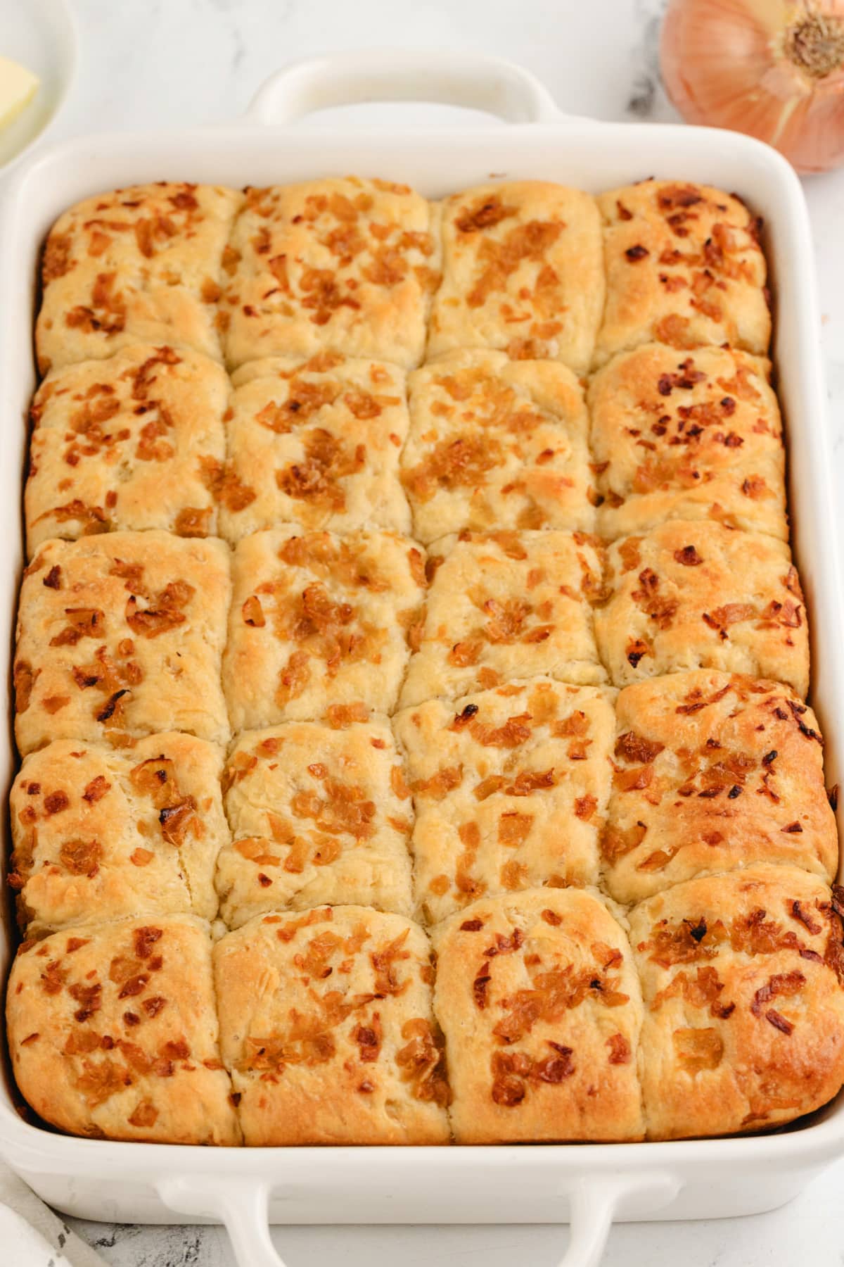 No-Knead Onion Rolls baked A full shot of a pan filled with golden, fluffy onion rolls, fresh from the oven.
