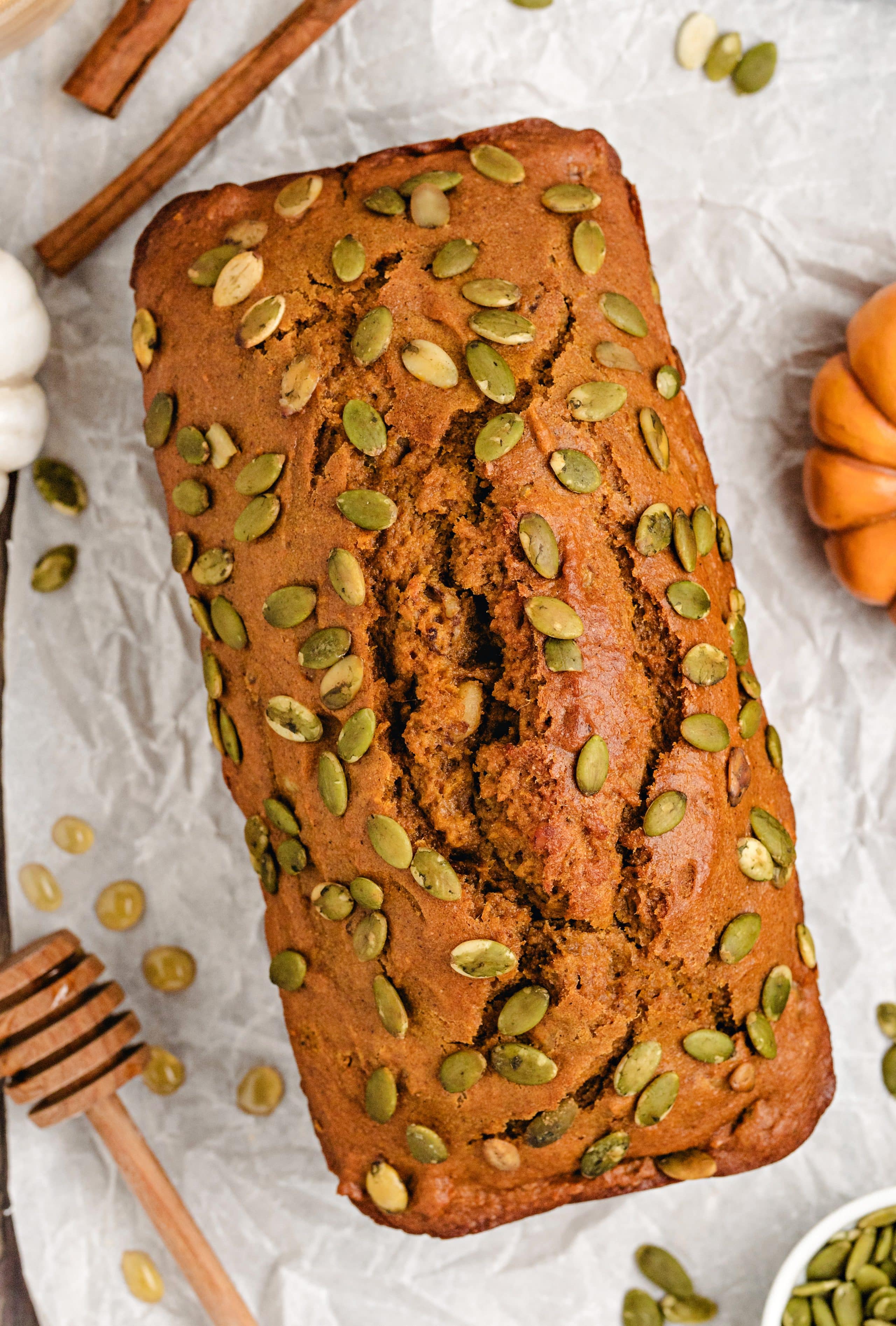 Lightened-Up Pumpkin Bread Lightened-up pumpkin bread loaf topped with pepitas.