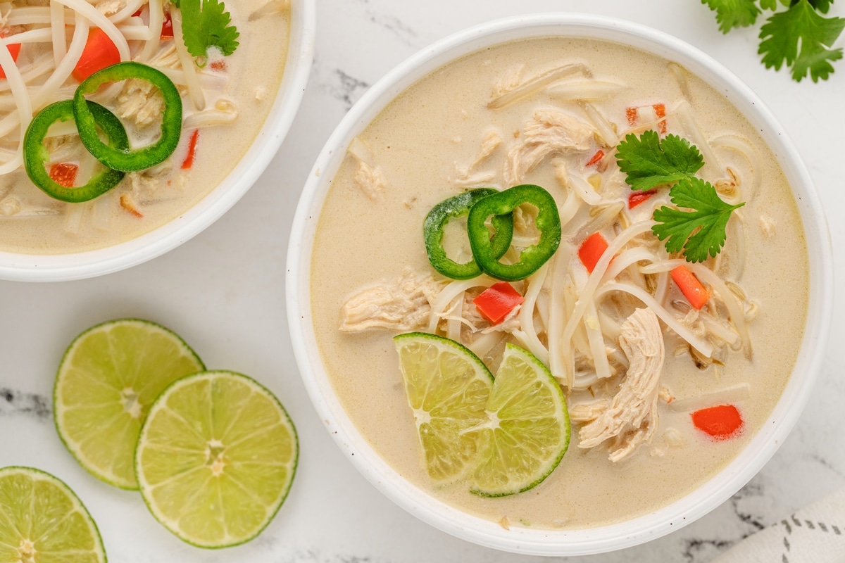 Garnished Slow Cooker Thai Chicken Noodle Soup Slow Cooker Thai Chicken Noodle Soup overhead shot with garnishes